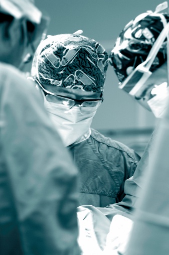 doctors perform hip revision surgery